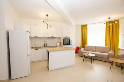 a kitchen and living room with a refrigerator and a couch at Oliva home in Utjeha