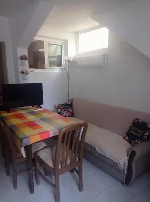 a small room with a table and a couch at Apartman Rogonjić in Sutomore