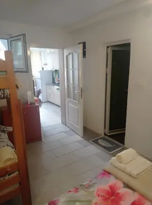 a room with a bedroom with a bed and a kitchen at Apartman Rogonjić in Sutomore