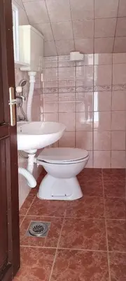 a bathroom with a toilet and a sink at Apartmani Pavlović in Becici