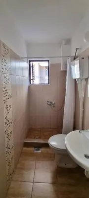 a bathroom with a toilet and a sink at Apartmani Pavlović in Becici