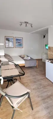 a living room with chairs and a couch at Apartmani Pavlović in Becici