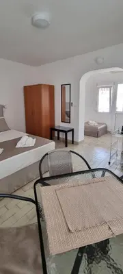 a bedroom with a bed and a glass table at Apartmani Pavlović in Becici