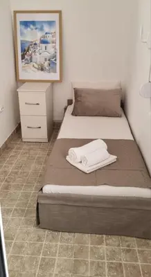 a bedroom with two beds and a painting on the wall at Apartmani Pavlović in Becici