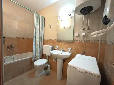 a bathroom with a toilet and a sink and a shower at Apartment Olea in Becici