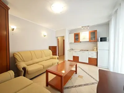 a living room with a couch and a table at Apartment Olea in Becici
