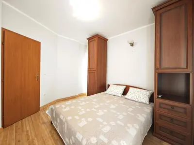 a bedroom with a bed and a wooden cabinet at Apartment Olea in Becici