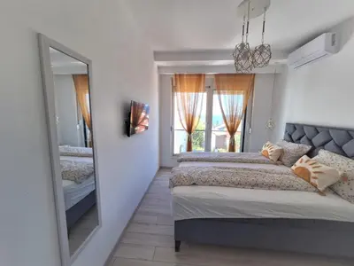 a bedroom with a large mirror and a bed at Larimar Cozy Apartment in Ulcinj