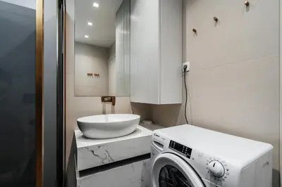 a laundry room with a sink and a washing machine at Przno Gate 114 By In Propety in Pržno