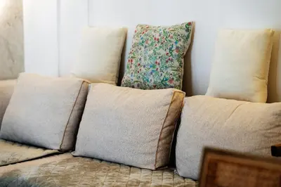 a couch with pillows on top of it at Przno Gate 114 By In Propety in Pržno
