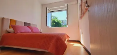 a bedroom with a bed with pink pillows and a window at Inspired by Nature in Podličak