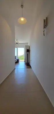 an empty room with a white wall and a hallway at Inspired by Nature in Podličak