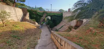 a small tunnel with a pathway leading to a small tunnel at Inspired by Nature in Podličak