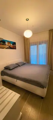 a bedroom with a bed and a chandelier at Azure Horizon Pržno in Sveti Stefan