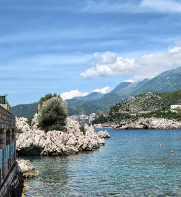 a view of a body of water with mountains at Azure Horizon Pržno in Sveti Stefan