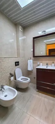 a bathroom with a toilet and a sink and a mirror at Azure Horizon Pržno in Sveti Stefan