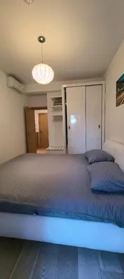 a bedroom with a large bed with a blue light at Azure Horizon Pržno in Sveti Stefan