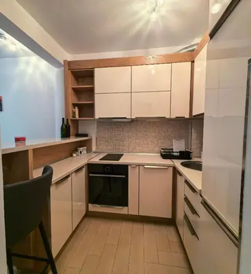 a kitchen with white cabinets and a stove top oven at Azure Horizon Pržno in Sveti Stefan