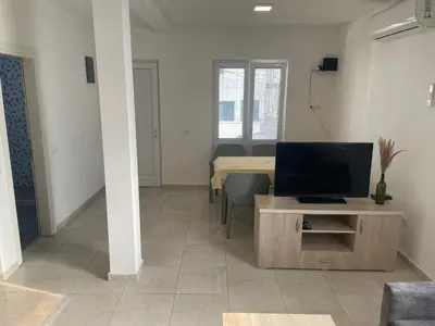 a living room with a tv and a table at New house in Dobra Voda