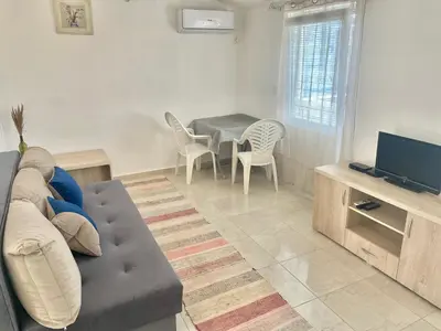 a living room with a couch and a table at New house in Dobra Voda