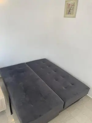 a bed sitting in a room next to a wall at New house in Dobra Voda