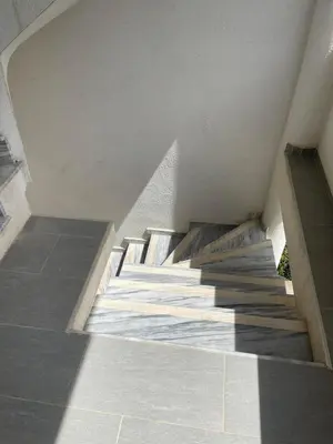 a staircase in a building with concrete floors and a white ceiling at New house in Dobra Voda