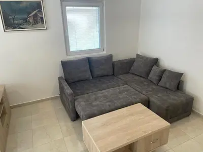 a living room with a couch and a coffee table at New house in Dobra Voda