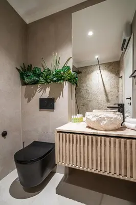 a bathroom with a black tub and a sink at Blanche Cliff Apartments in Sveti Stefan