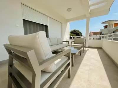 a balcony with chaise lounge chairs on a roof at Belvedere Apartments in Ulcinj