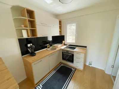 a small kitchen with white cabinets and a sink at Belvedere Apartments in Ulcinj