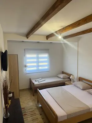 a room with two beds and a window at Villa Miki in Kruče