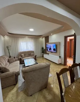 a living room with couches and a flat screen tv at Villa Miki in Kruče