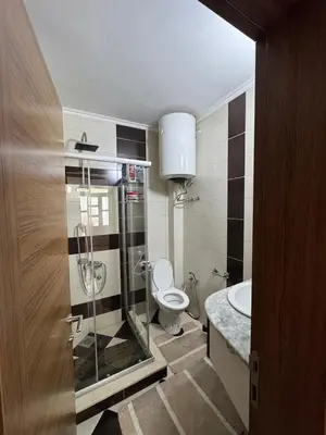 a bathroom with a toilet and a glass shower at Villa Miki in Kruče