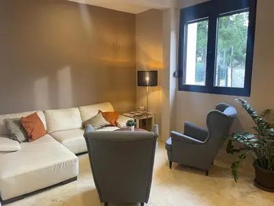 a living room with a couch and a chair at Apartments Kuce Lekovica Beach & snack bar- Bistro in Bar