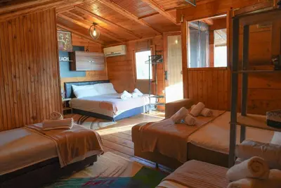 a bedroom with two beds in a wooden cabin at Ada Dream House in Kravlja