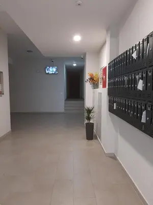 a hallway of a building with a room with a bunch of glasses at Titograd in Podgorica