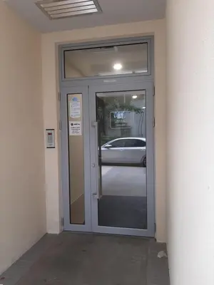 a door to a building with a car outside at Titograd in Podgorica