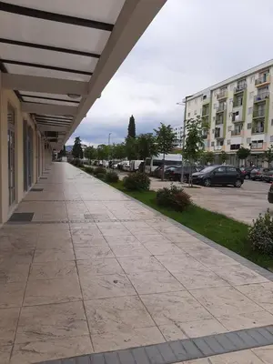 an empty sidewalk in front of a building at Titograd in Podgorica
