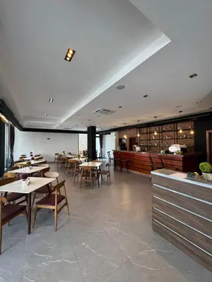 a dining room with tables and chairs and a restaurant at Stan Pinjes - Ulcinj in Ulcinj
