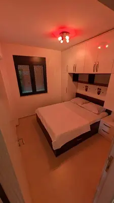 a bedroom with a bed and a red light at Sutomore - Lux apartment 1 in Sutomore