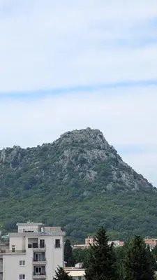 a mountain in the distance with a building in front of it at Sutomore - Lux apartment 1 in Sutomore