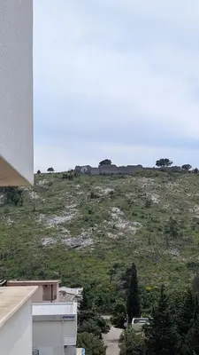 a view of a hill with trees and buildings at Sutomore - Lux apartment 1 in Sutomore