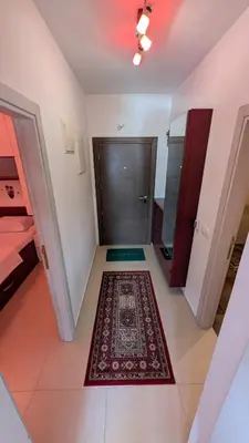 a hallway with a door and a rug on the floor at Sutomore - Lux apartment 1 in Sutomore