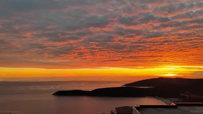 a sunset over a body of water with the sun setting at The best sea view in Prijevor