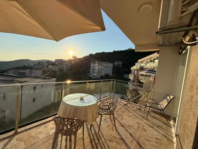 a patio with a table and chairs on a balcony at The best sea view in Prijevor