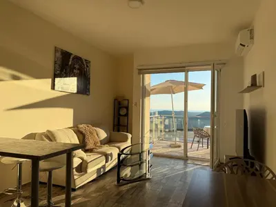 a living room with a couch and a table at The best sea view in Prijevor