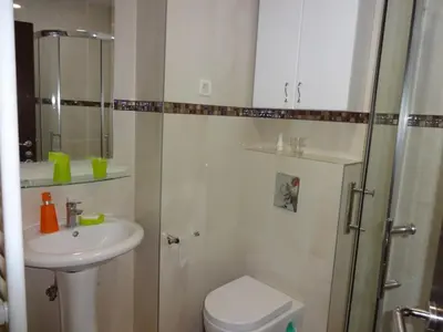 a bathroom with a toilet and a sink and a shower at Nataliia Twister Apartment in Budva