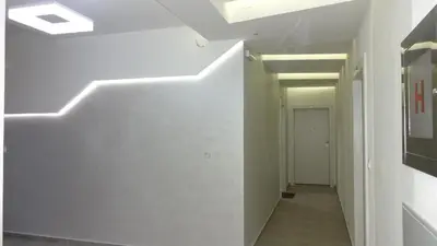 a hallway with white walls and a hallway with a white hallway at Nataliia Twister Apartment in Budva