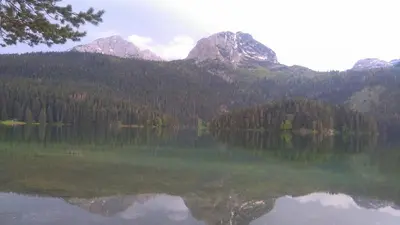 a view of a lake with mountains in the background at Nataliia Twister Apartment in Budva