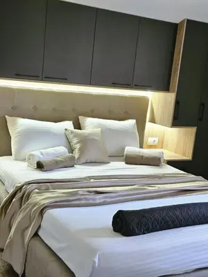 a large bed with two pillows on top of it at V&L Apartman in Kravlja